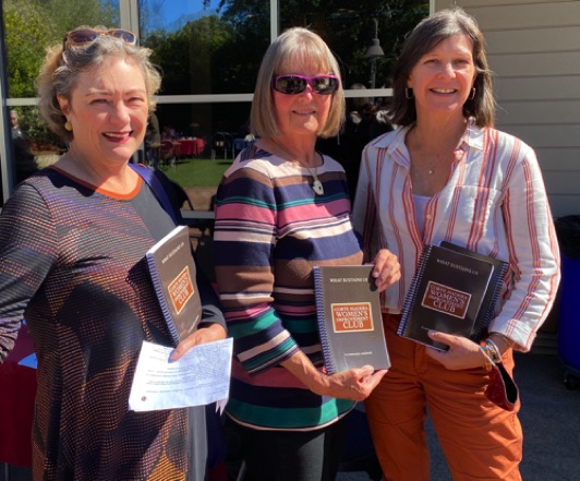 Claudia (Center) and Armelle (R), shepherds of the cookbook project, celebrate with Club President Laura (L).